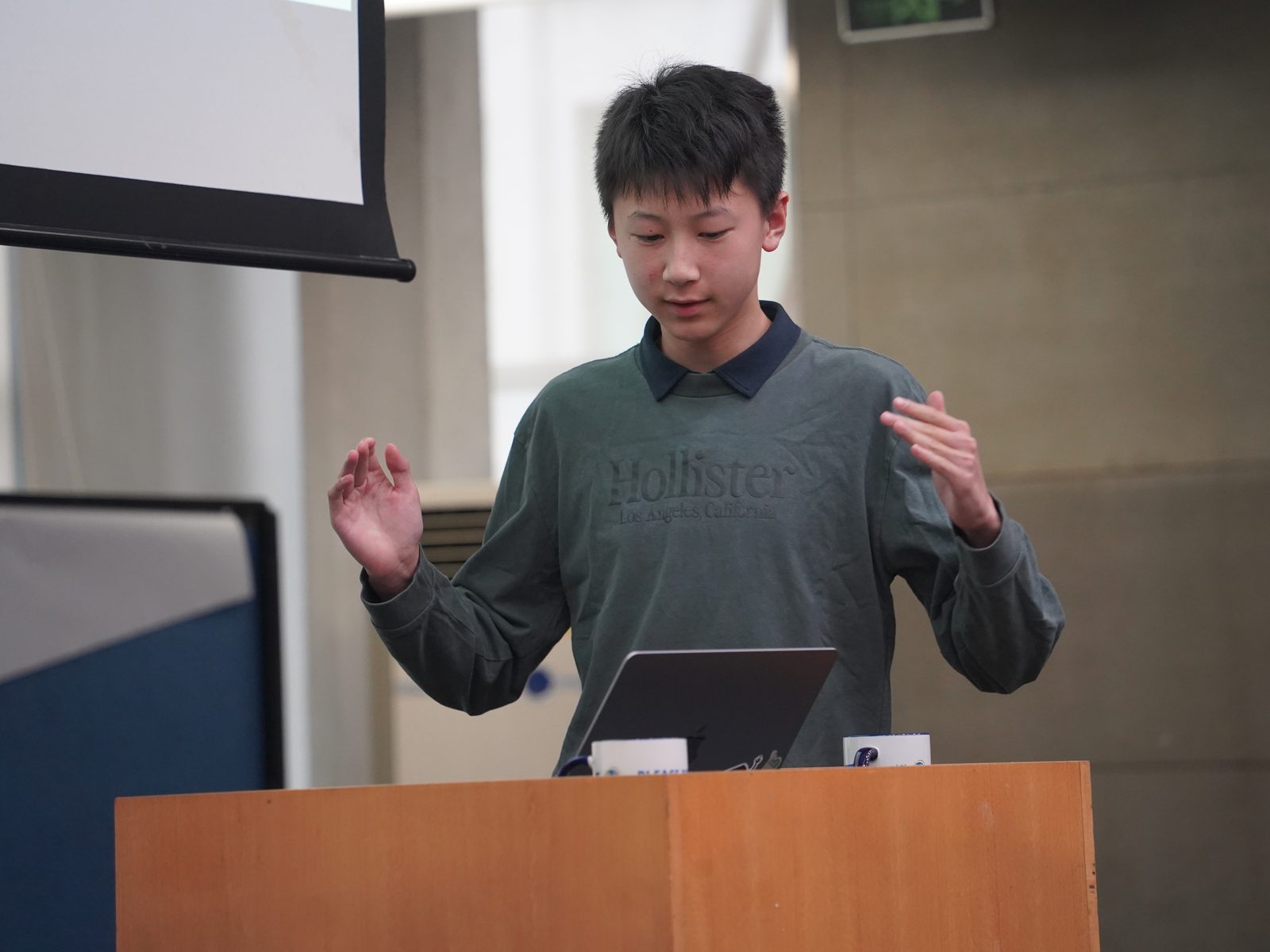 A student explaining his product at the podium