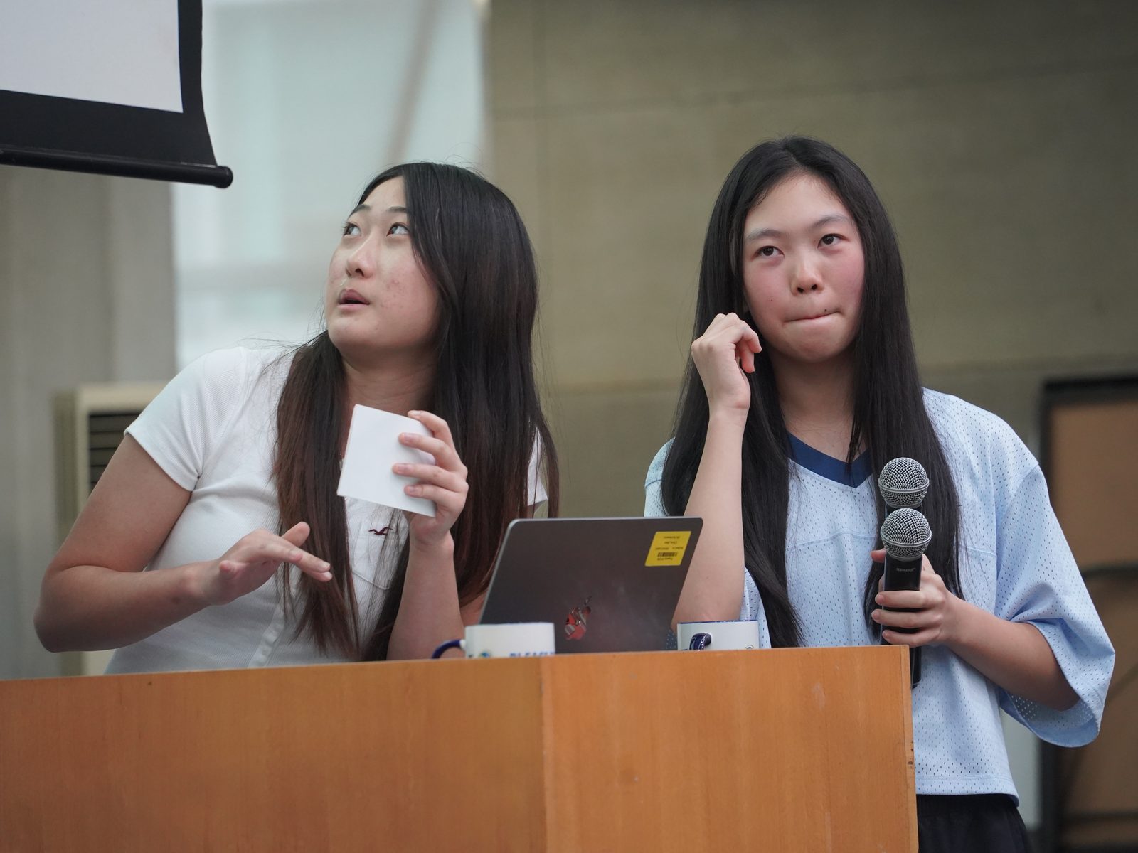Two students answering questions at the podium