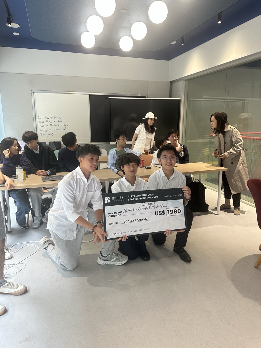 Phillip handing the pitch-winner check to the student team